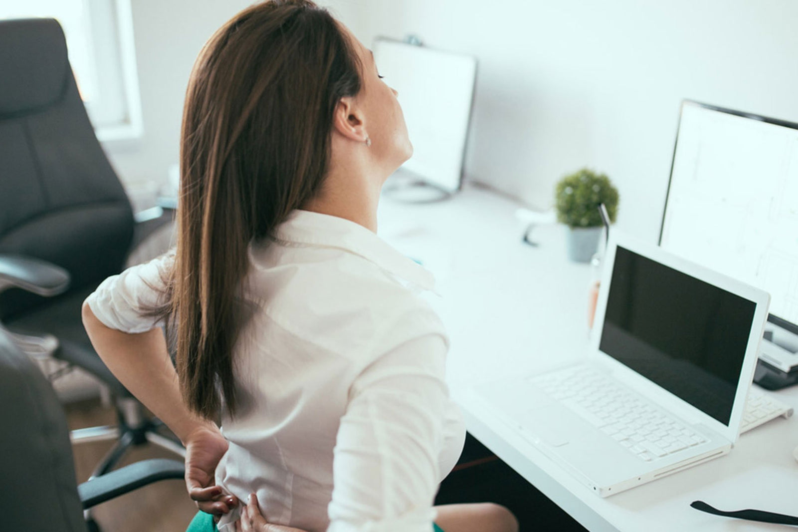 Woman having back pain symptoms