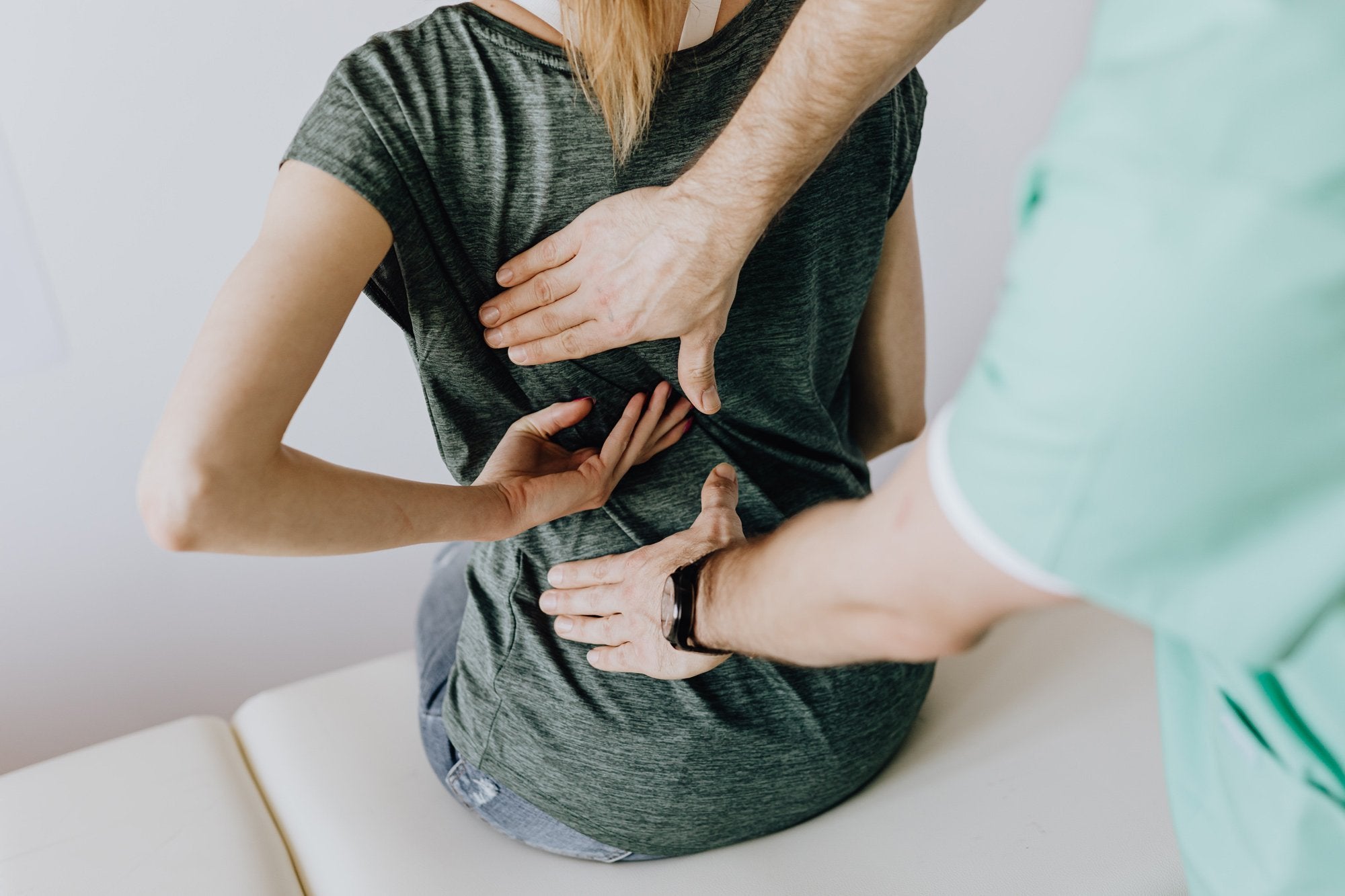 Woman showing chiropractor painful